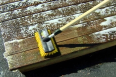 brushing the deck restoration cleaning solution 